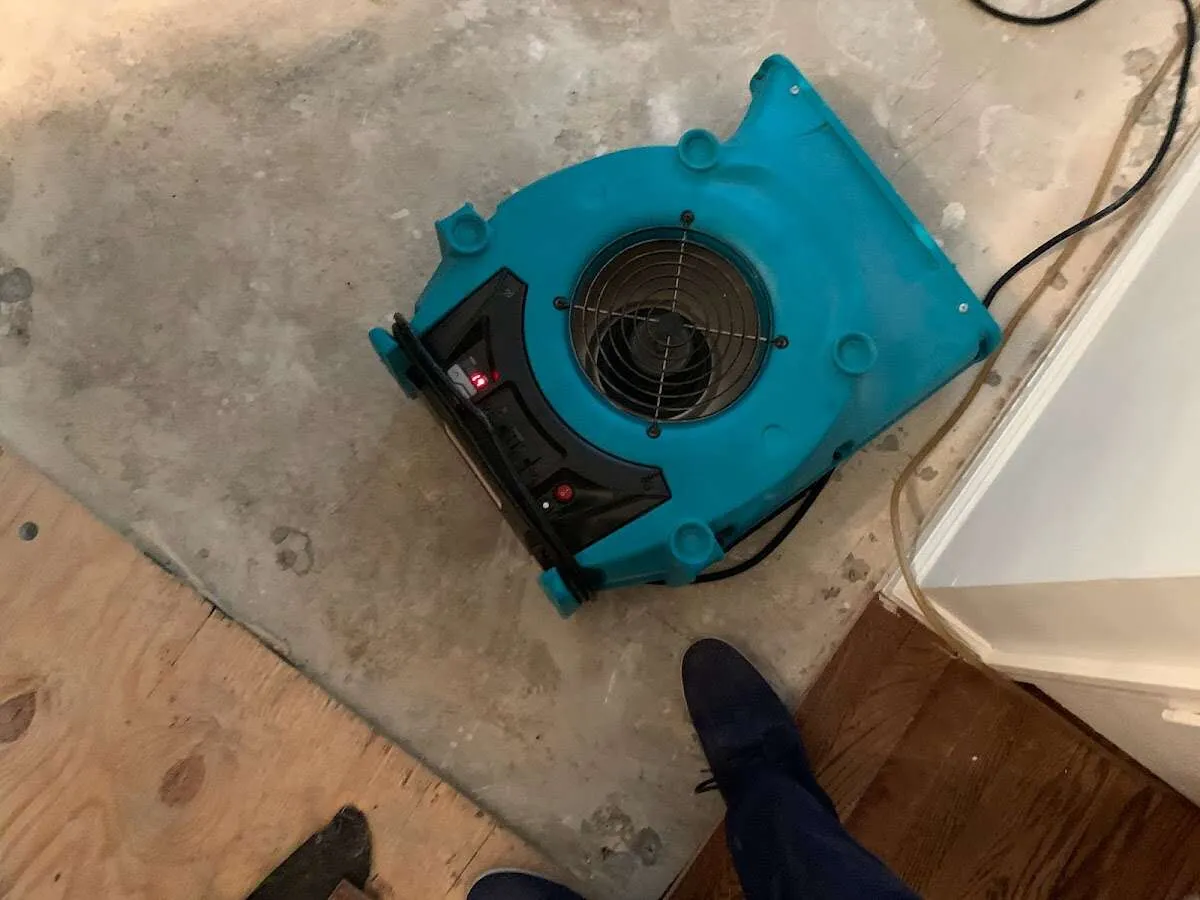 Air mover drying subfloor during Commercial Water Damage Restoration in Gibsonville